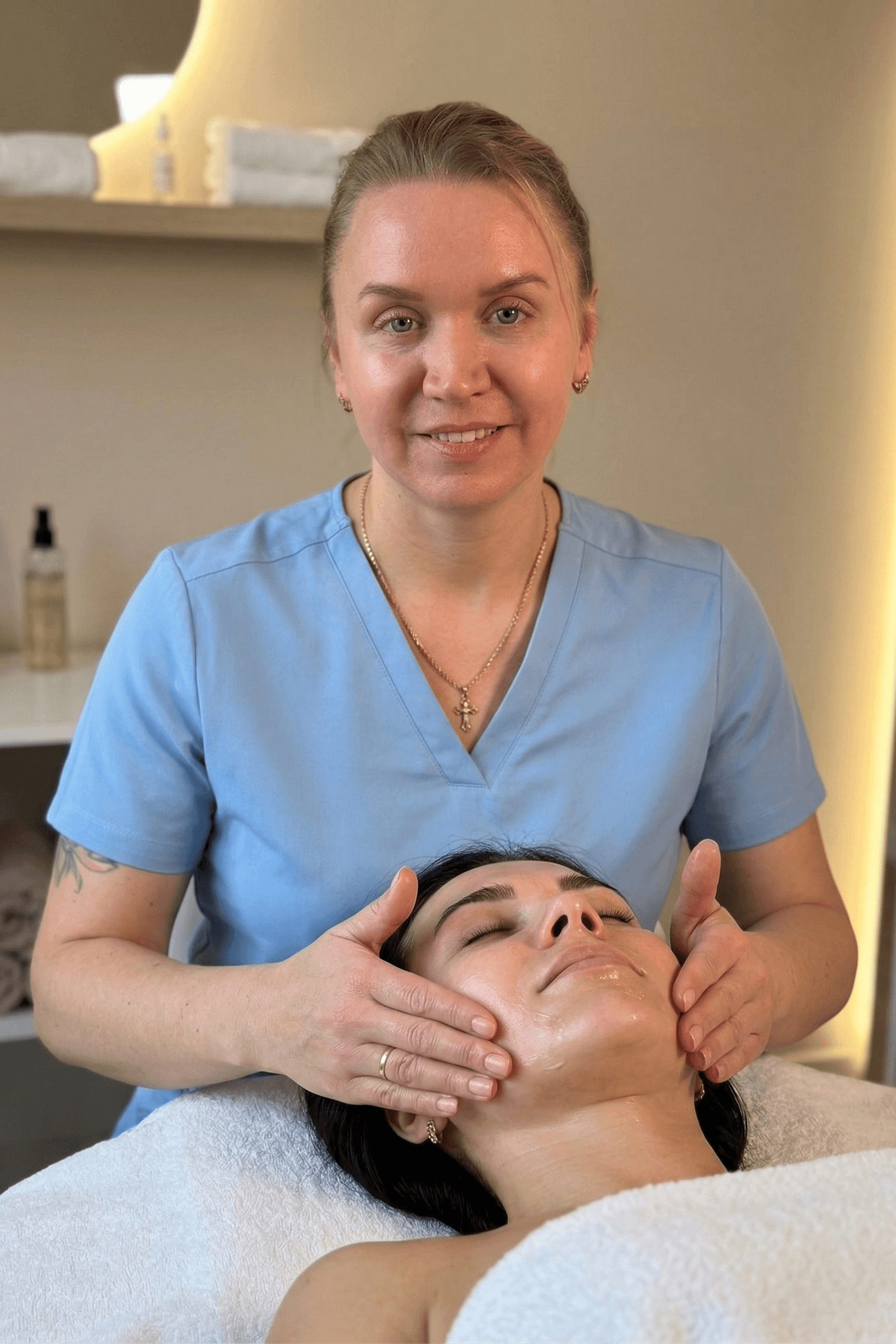 Therapist performing a professional facial treatment on a client in a private treatment room