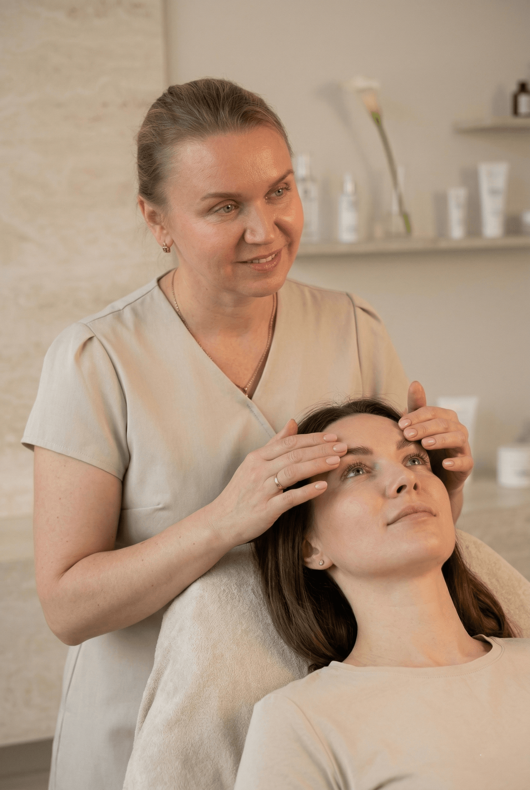 Therapist checking a client’s lashes and brows during a professional beauty treatment