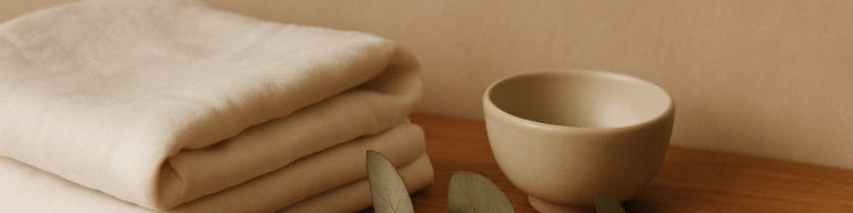 Treatment-room linen, ceramic bowl, eucalyptus on warm wood. Beauty treatments. Skincare & Waxing Kirkham.